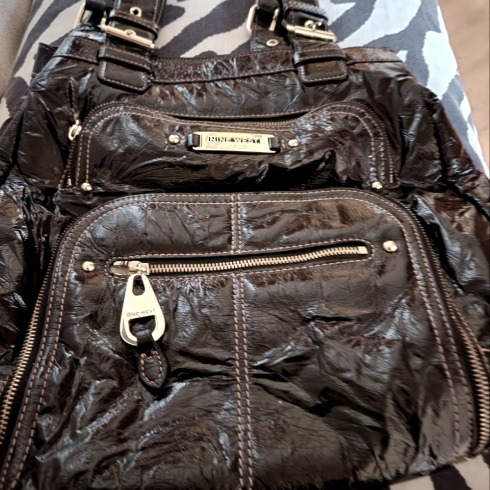 Women's Nine West Black Vinyl shoulder bag with side zipper pocket.
